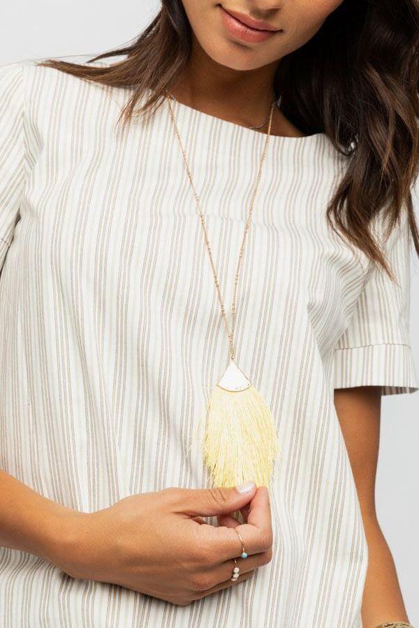 Lovely golden tassel necklace! Pair it with a top in ivory to make a chic look.