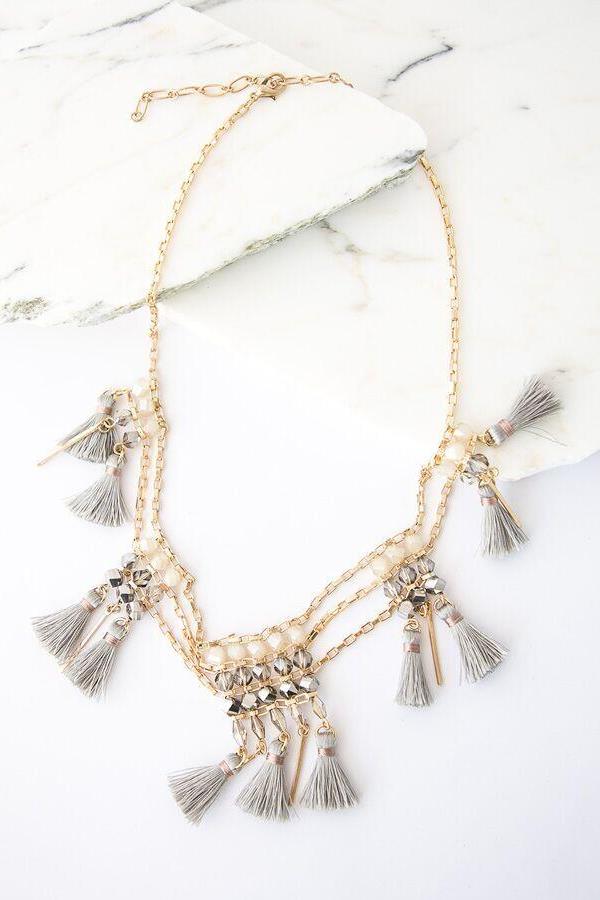 i love this tassel beaded necklace in grey and gold !