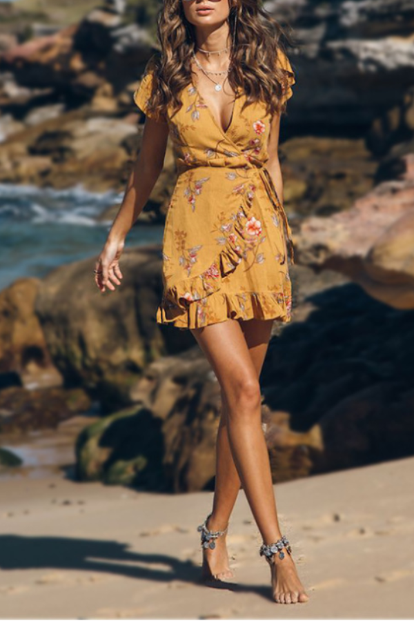 lovely printed mustard dress with v-neck and ruffles in the hem I love for a beach day