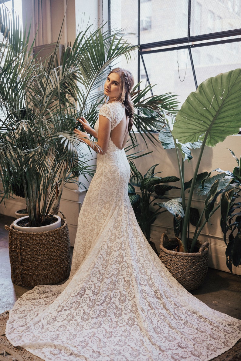 simple and elegant lace bohemian wedding dress with open back, long train and cap sleeves